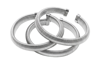 Stack of three Elorae silver Metropolis coil bangles on a white background.